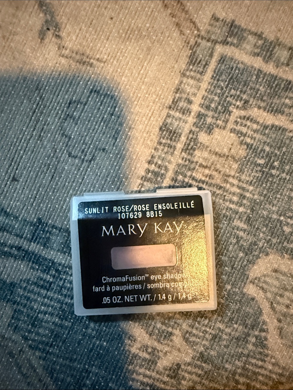 Small cosmetic item on fabric